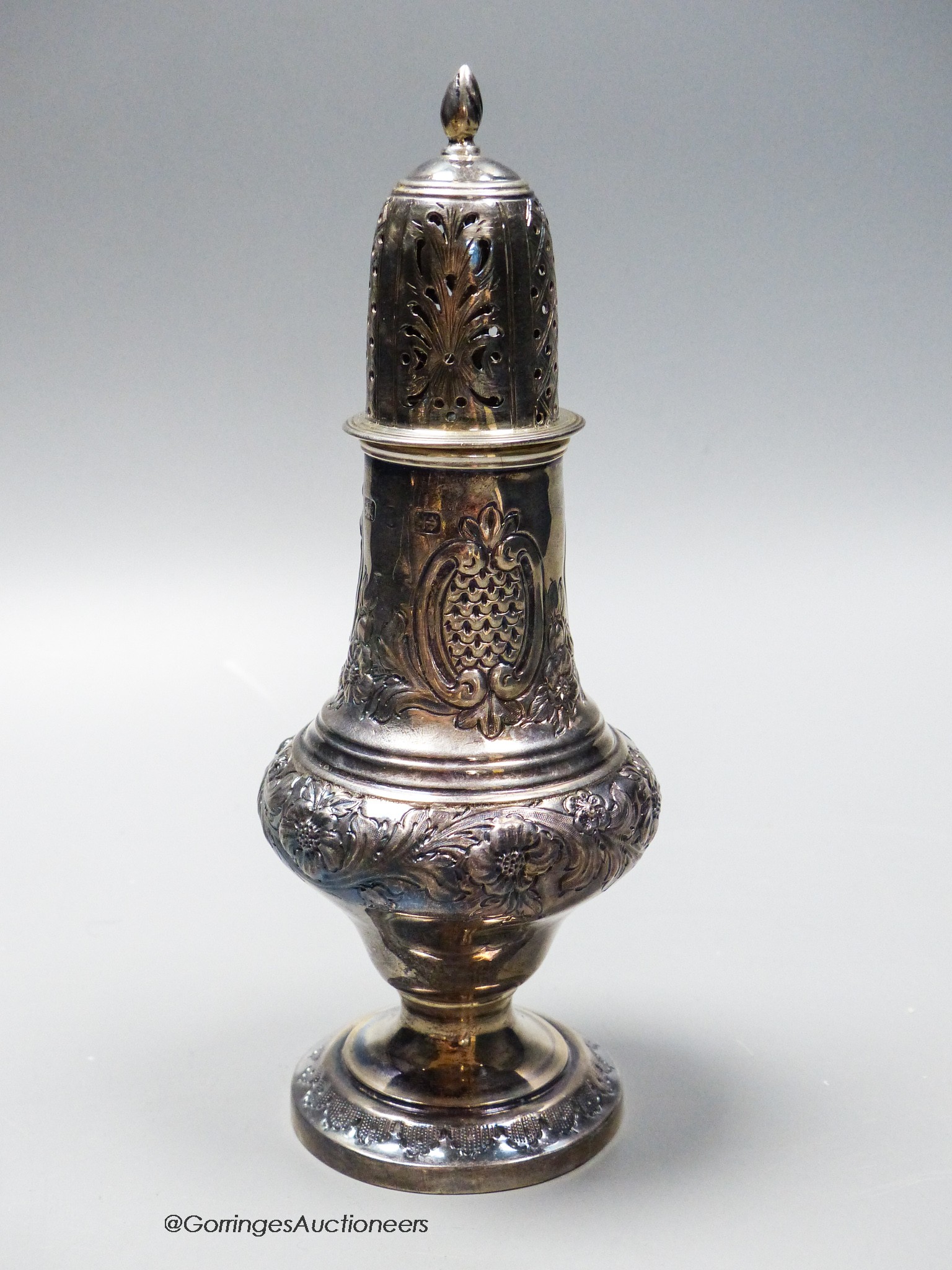 A late Victorian repousse silver sugar caster, marks rubbed, 18.5cm, 4oz.